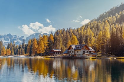 White and brown house near a body of water during daytime