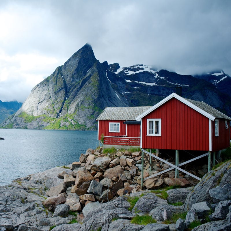 Red wooden house near sea