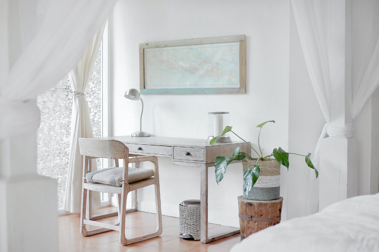 Wooden desk and chair near the window.