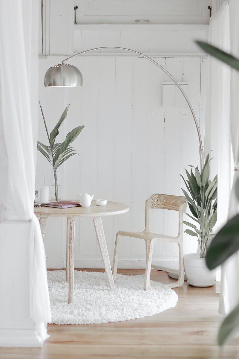 White steel chair in front round table